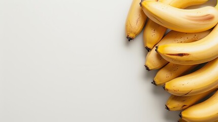 Wall Mural - ripe bananas, yellow hue, white setting. copy space available.