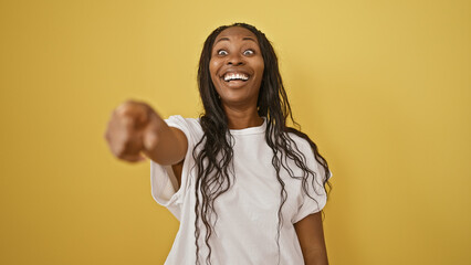 Sticker - Laughing young woman with curly hair pointing at camera isolated on yellow background