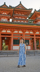 Sticker - Beautiful hispanic woman confidently standing, enjoying and smiling while looking around the traditional heian jingu shrine, kyoto, japan