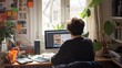 © SprintZz - A young man sits at a desk in a home office, working on a computer with a window and plants in the background.