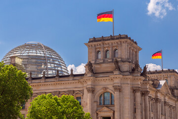 Wall Mural - Glass dome and waving German national flags on the Reichstag building. Berlin.