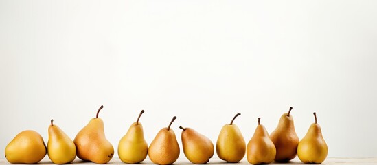Poster - A scene showing ripe pears arranged neatly on a clean white surface with empty space for text or other elements in the image. with copy space image. Place for adding text or design