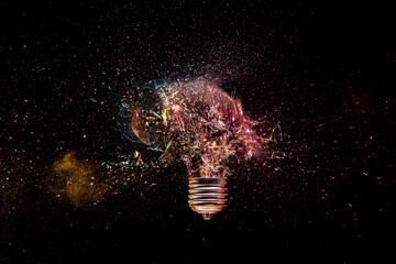 Fototapete - Shattered light bulb moment on dark background