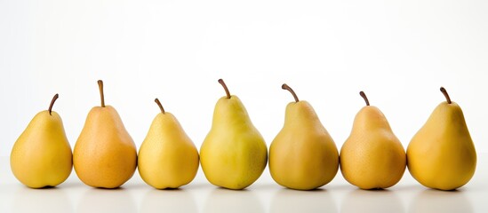 Fototapete - A scene showing ripe pears arranged neatly on a clean white surface with empty space for text or other elements in the image. with copy space image. Place for adding text or design