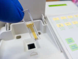 Wall Mural - Optical measurement of the color of the test liquid in a cuvette using a spectrophotometer.