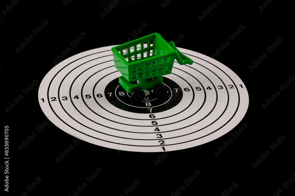 Miniature shopping cart from a supermarket and a shooting target on a ...