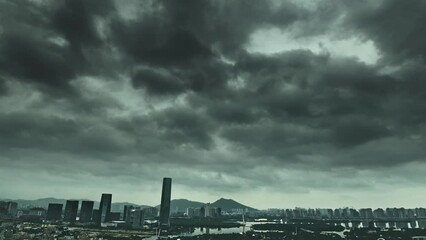 Wall Mural - Time lapse of dark clouds over a city