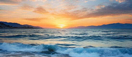Aufkleber - Sunset over the sea with a tranquil tide and a beautiful view in the background with copy space image.