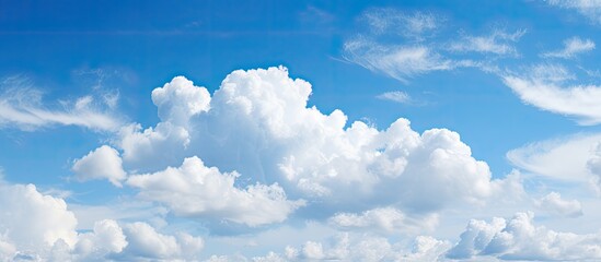 Aufkleber - The expansive blue sky with fluffy clouds provides a serene background for copy space image.
