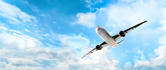 Wall Mural - white passenger airplane is flying high in the clear blue sky, symbolizing freedom and adventure