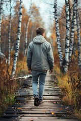 Aufkleber - A person strolling along a rustic forest trail, surrounded by trees and foliage