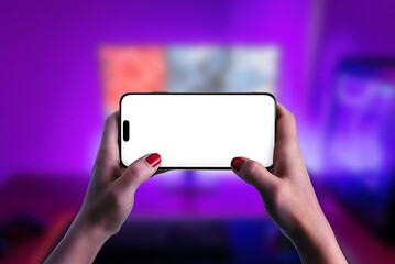 Wall Mural - Hands engaged in gameplay on a smartphone, emphasizing an isolated screen for mockup purposes. Ideal for gaming and technology promotions