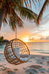 Poster - Sunset landscape of sandy beach and ocean with rattan swing lounger on palm tree