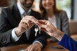 © Nognapas - Cropped close up view happy couple receiving keys from new own property, finish meeting in real estate agency lead by realtor in formal suit. Bank mortgage for young family, selling, renting concept
