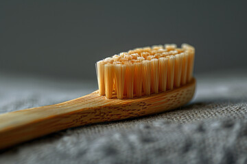 Aufkleber - A compostable bamboo toothbrush placed diagonally on a minimalist grey background,