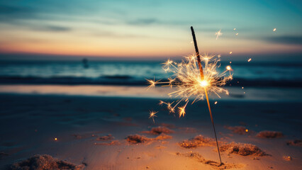 Single sparkler on a beach at sunset

