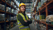 © Michael - Young woman in a hard hat and reflective vest posing in a warehouse
