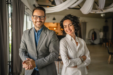 Portrait of colleagues man and woman stand at cafe or restaurant