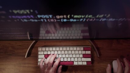 Hands of Professional Programmer is typing code. Top down shot