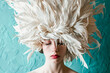 © ADDICTIVE STOCK - Woman adorned with an elaborate white feather headpiece. Generative AI image