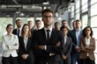 © mattegg - Business leader standing in front of his team in an office setting