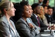 © mattegg - A group of business professionals attentively listen during a conference session