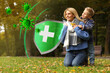 © New Africa - Happy mother with her son on green grass in autumn park. Strong immunity - shield against viruses