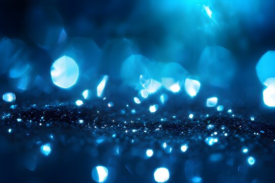 blue glitter scattered across a surface catching light shimmering with bokeh background highlight. 