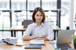 © David - Happy asian business woman entrepreneur in office using laptop at work, smiling professional female company executive wearing suit working on computer at workplace.