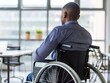 © VISUAL BACKGROUND - A man in a wheelchair looking out of an office.