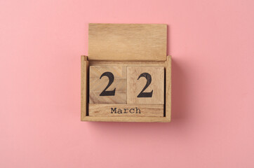 Sticker - Wooden block calendar with date March 22 on pink  backround. Top view. Flat lay