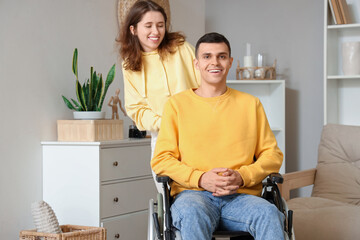 Canvas Print - Young man in wheelchair with his girlfriend at home