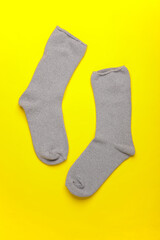 Sticker - Pair of gray socks on a yellow background