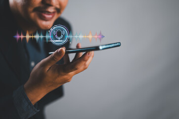 Fototapete - Man using voice assistant on smartphone, talking to smartphone for Access to information and applications, Write a message and send a message.