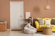 © Pixel-Shot - Interior of stylish living room with yellow sofa and wooden coffee table near beige wall