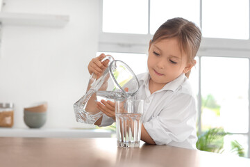 Poster - Cute little girl pouring water into glass in kitchen