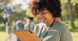 © peopleimages.com - Woman, volunteer and happy nature with tablet in outdoor, community work and environment sustainability project with group. Recycle, waste management and cleaning outside trash, help and ngo support