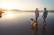 © peopleimages.com - Beach, sunset and couple with dog on sand for outdoor travel, trust and summer vacation together. Man, woman and nature with furry pet by ocean for support, love and tourist holiday in Cancun