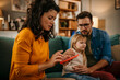 © La Famiglia - Anxious young Caucasian mom call ambulance doctor take care of sick small girl child having flu and high temperature. Worried family contact therapist