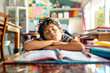 © Jane_S - Boy asleep on a desk with school books and colorful sticky notes in the background.