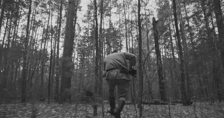 Wall Mural - Reenactor Dressed As Russian Soviet Infantry Soldier Of World War Ii Run With Rifle Mosin Nagant. War Combat In Forest. Red Soviet Army Military Uniform. Reenactment Tactic Game. Black And White Video