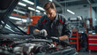 © Alice a. - A man in a blue jacket is working on a car engine. He is wearing gloves and he is focused on the task at hand. Concept of diligence and expertise