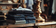 © Svetlana - close-up of neatly folded blue denim clothes on a table against the background of a gilded vase in an antique boutique, vintage style desktop wallpaper