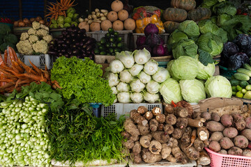 Beautifully arranged fresh vegetables at a traditional market, for sale.