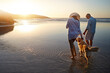 © GR/peopleimages.com - Beach, walk and couple with dog at sunset for outdoor adventure, travel and holiday together. Peace, man and woman with furry pet by ocean water for support, love and summer vacation in California