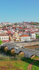 Wall Mural - Aerial view of Silves medieval town in Algarve region of Portugal. Flying over Silves old town. Ancient roman bridge, Cathedral church, old fortress and historic buildings