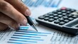 © CHAKKAPONG - Person using a calculator to analyze investments