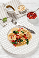 Wall Mural - italian pasta mezzelune on a plate, top view