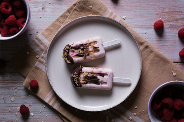 Raspberry ice cream on a plate with soft light on top. Pink ice cream