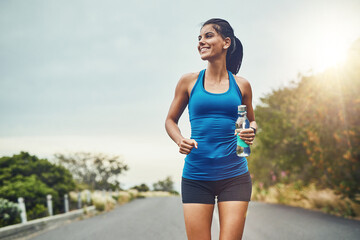 Thinking, runner or happy woman drinking water on break to hydrate or relax for healthy energy in exercise. Fitness, smile and thirsty athlete with liquid or hydration in marathon training or workout